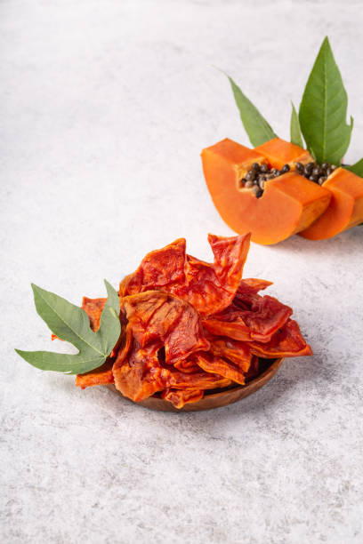 dried papaya slices on white background. - verticak imagens e fotografias de stock