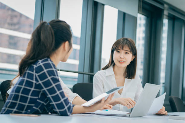 istock Asian chinese white collar worker teamwork discussion in the office 1291961052