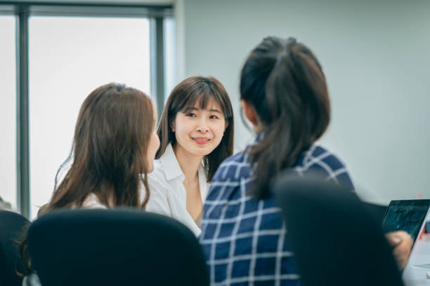 istock Asian chinese white collar worker teamwork discussion in the office 1291961061