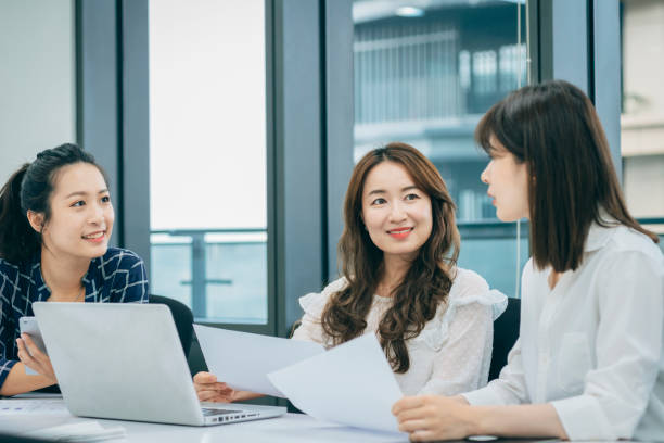 istock Asian chinese white collar worker teamwork discussion in the office 1291961071