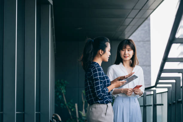 istock Asian chinese white collar worker teamwork discussion in the office 1291961125