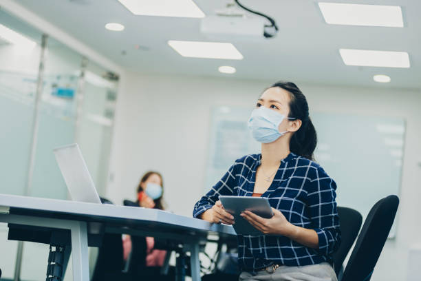 istock Business person with face mask discuss work after office reopen 1291961562