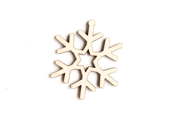 istock Wooden snowflake isolated on white background, top view 1291964279