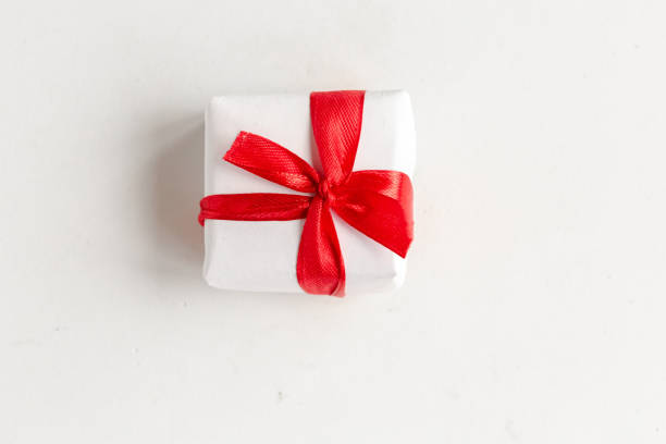 istock Gift box with red bow on white background, top view 1291964291
