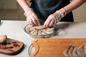 Woman ordering fresh prawn for cooking in the glass bowl