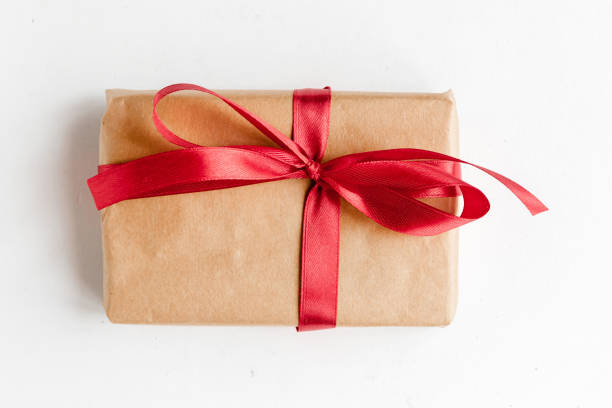 istock Gift box with red bow on white background, top view 1291964365