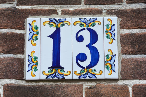 istock Number 13 on the house wall 1291964452