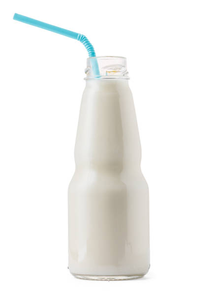 istock Glass cup of milk with a straw isolated on white 1291966389
