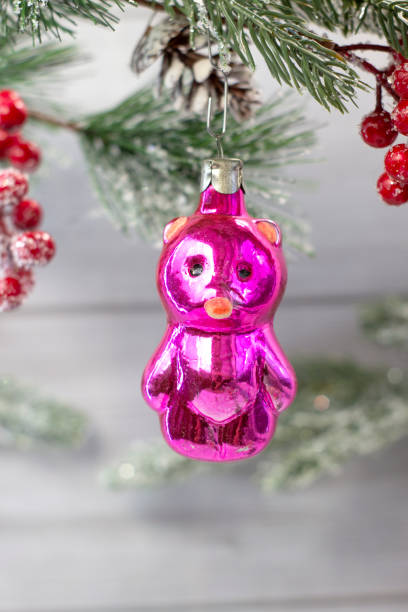 istock Old soviet decoration on the Christmas tree, glass toy teddy bear close up on light background 1291970306