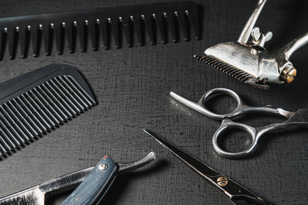 istock vintage barber tools. dangerous razor, hairdressing scissors, old manual clipper, combs, shaving brush. black monochrome 1291970576