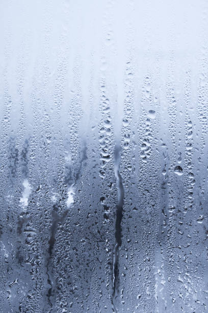 istock Raindrops on window glass. Abstract background. Blue tone 1291971174