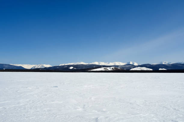 istock Baikal mountains in winter in snow. Forest in snow covered mount 1291971439
