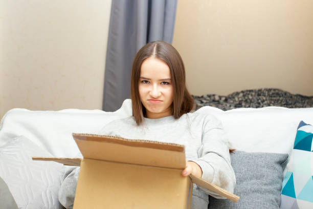 istock The frustrated woman opens the package box 1291974023