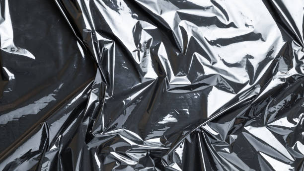 istock Plastic bag texture. Wrap transparent dark cellophane background. Black shiny film pattern for packaging, product protection. 1291975870
