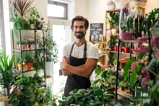 istock Man Standing in His Flower Shop 1291979011