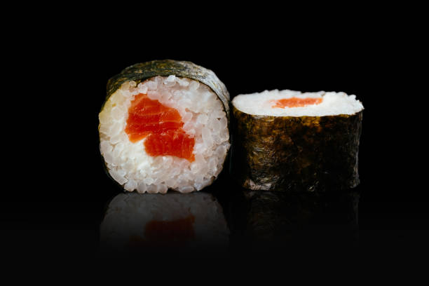istock Japanese sushi rolls on a black background 1291979631