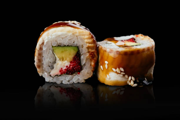 Japanese sushi rolls on a black background