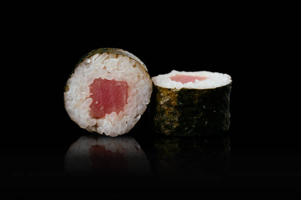 istock Japanese sushi rolls on a black background 1291979634