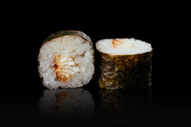 istock Japanese sushi rolls on a black background 1291979646