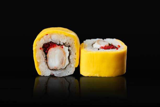 istock Japanese sushi rolls on a black background 1291979652