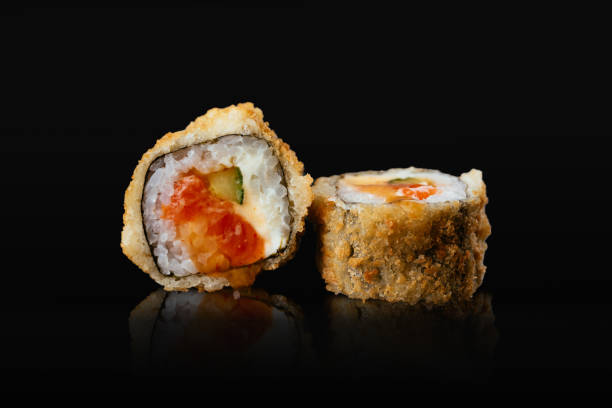 istock Japanese sushi rolls on a black background 1291979672