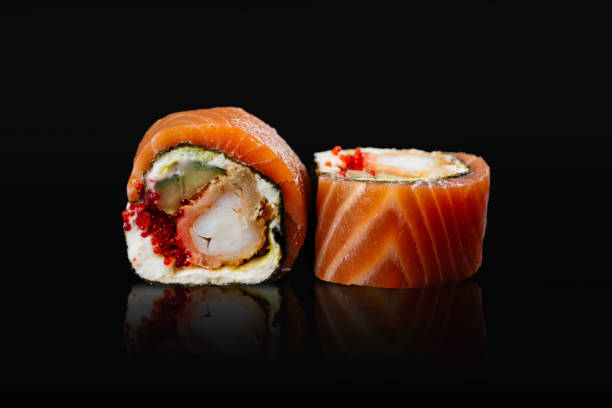 istock Japanese sushi rolls on a black background 1291979687