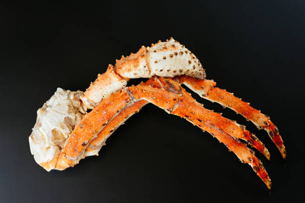 istock Kamchatka crab legs on a black background 1291979691