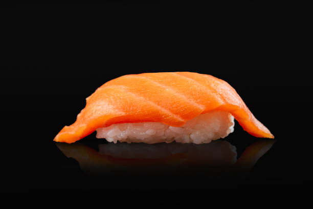 istock Japanese sushi rolls on a black background 1291979696