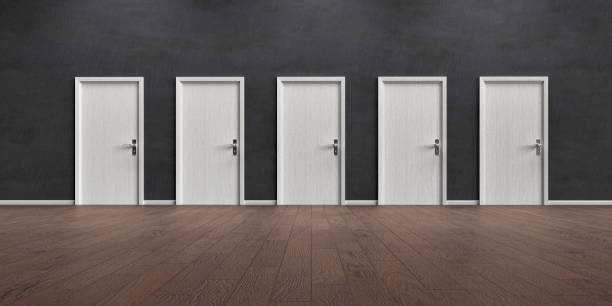istock Grey wall with five closed doors and wooden floor 1291980834