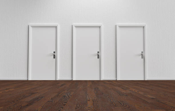 White wall with three closed doors and wooden floor stock photo