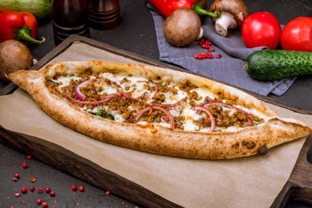 istock Turkish pide with minced meat and cheese and sliced red onion 1291981321