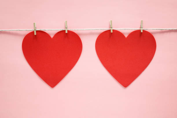istock Red hearts on pink background 1291981886