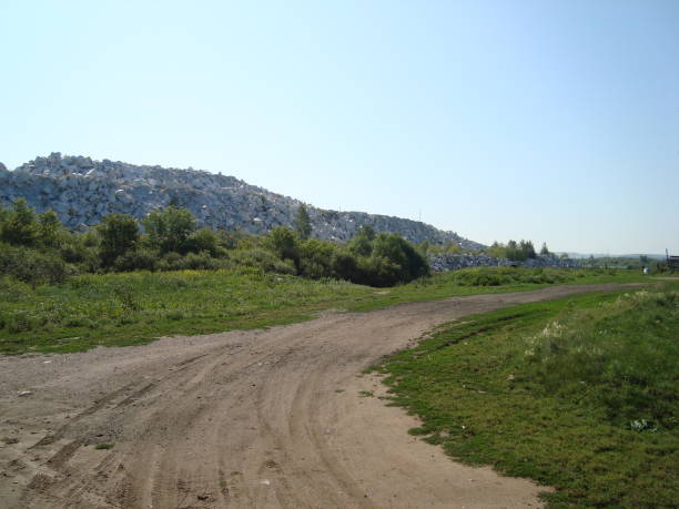 istock Summer village scenery with road and trees 1291983391