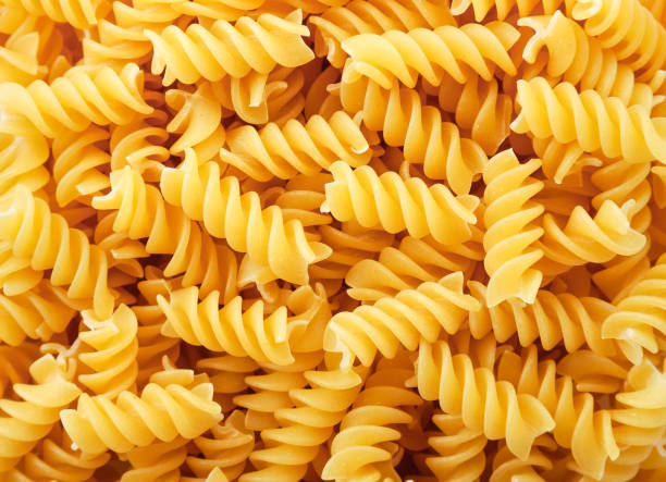 istock Spiral shape pasta, background texture. The view from top 1291986287