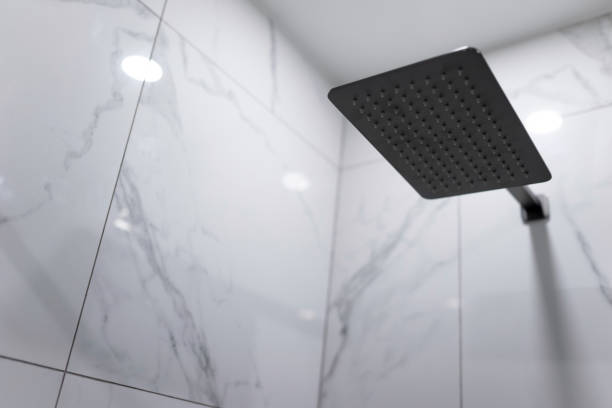 istock Jet rain shower head on the ceramic wall 1291986588