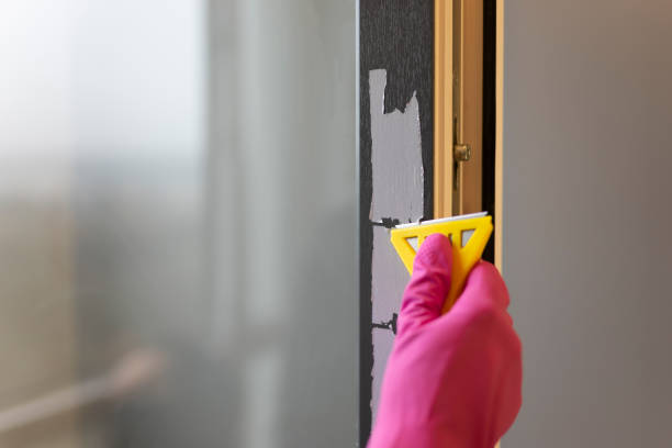 Removing protective tape from the window frame with scraper Removing protective tape from the window frame with scraper scraper stock pictures, royalty-free photos & images