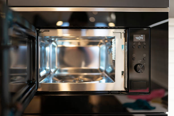 istock Modern built-in microwave microwave oven with open door. Empty microwave concept 1291986687