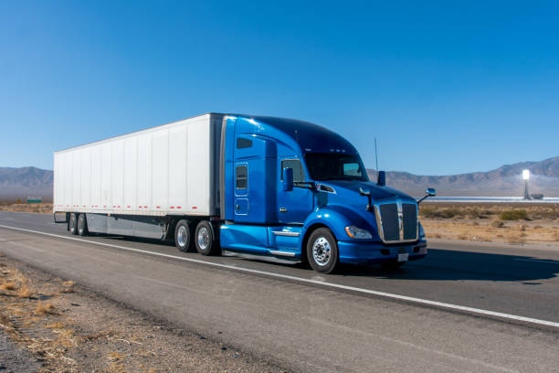 istock Long Haul Semi Truck on A Two Way Highway 1291987564