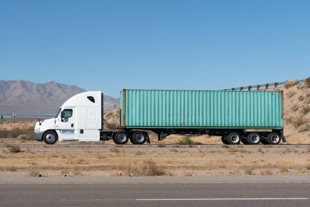 istock Long Haul Semi Truck on A Two Way Highway 1291987597