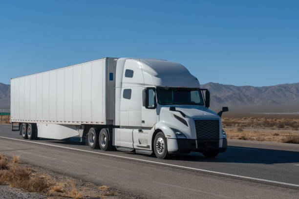 istock Long Haul Semi Truck on A Two Way Highway 1291987640