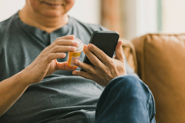 istock Unrecognizable senior compares medication with information on web 1291988877