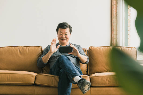 istock Senior man smiles and waves for selfie 1291988890
