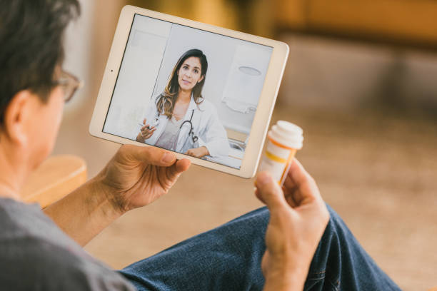 istock Man has virtual appointment with doctor while self-isolating during COVID-19 1291988918