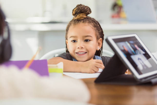istock While older siblings learn from home, preschool girl colors 1291989013