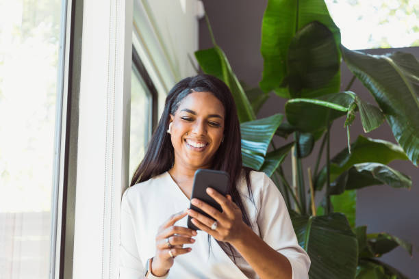 istock Woman uses phone to take selfie at work 1291989038
