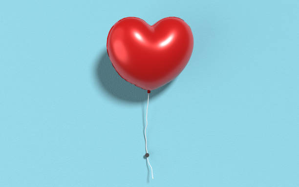 istock Red Helium Balloon in Heart Shape on Blue Painted Wall 1291991151