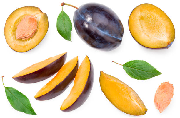 istock fresh plum fruit with green leaf and cut plum slices isolated on white background. Clipping path. top view 1291994070