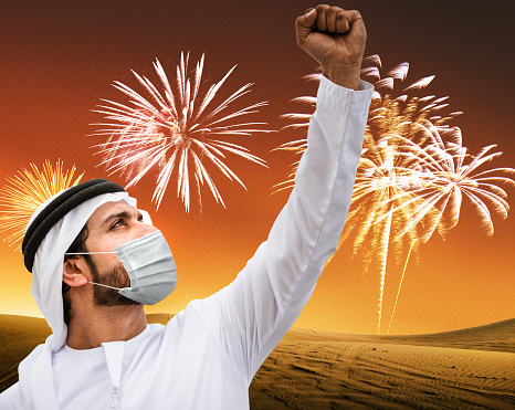 success man with face mask celebrate the new year