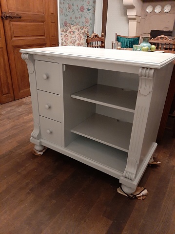 Upgrade of a damaged old cabinet or cupboard. Restored, sanded and just painted in a light blue grey color.