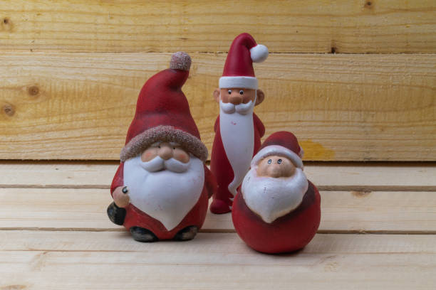istock Red Santa Clauses on rustic wooden boards as Christmas decorations. 1292000143